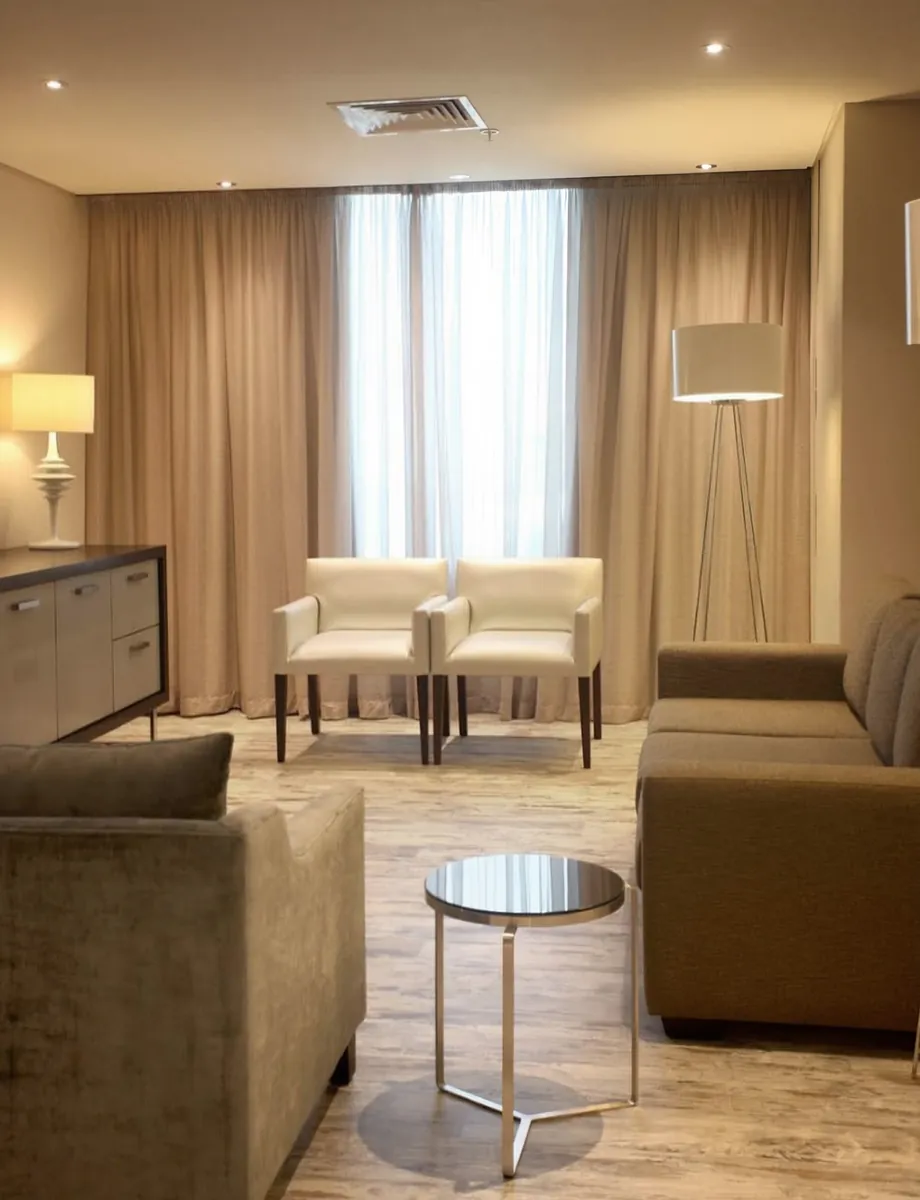 Suite lounge with sofas, armchairs and a floor lamp