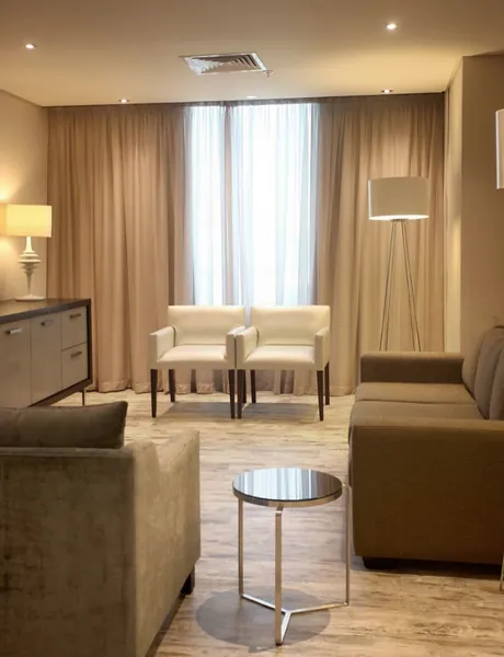 Suite lounge with sofas, armchairs and a floor lamp